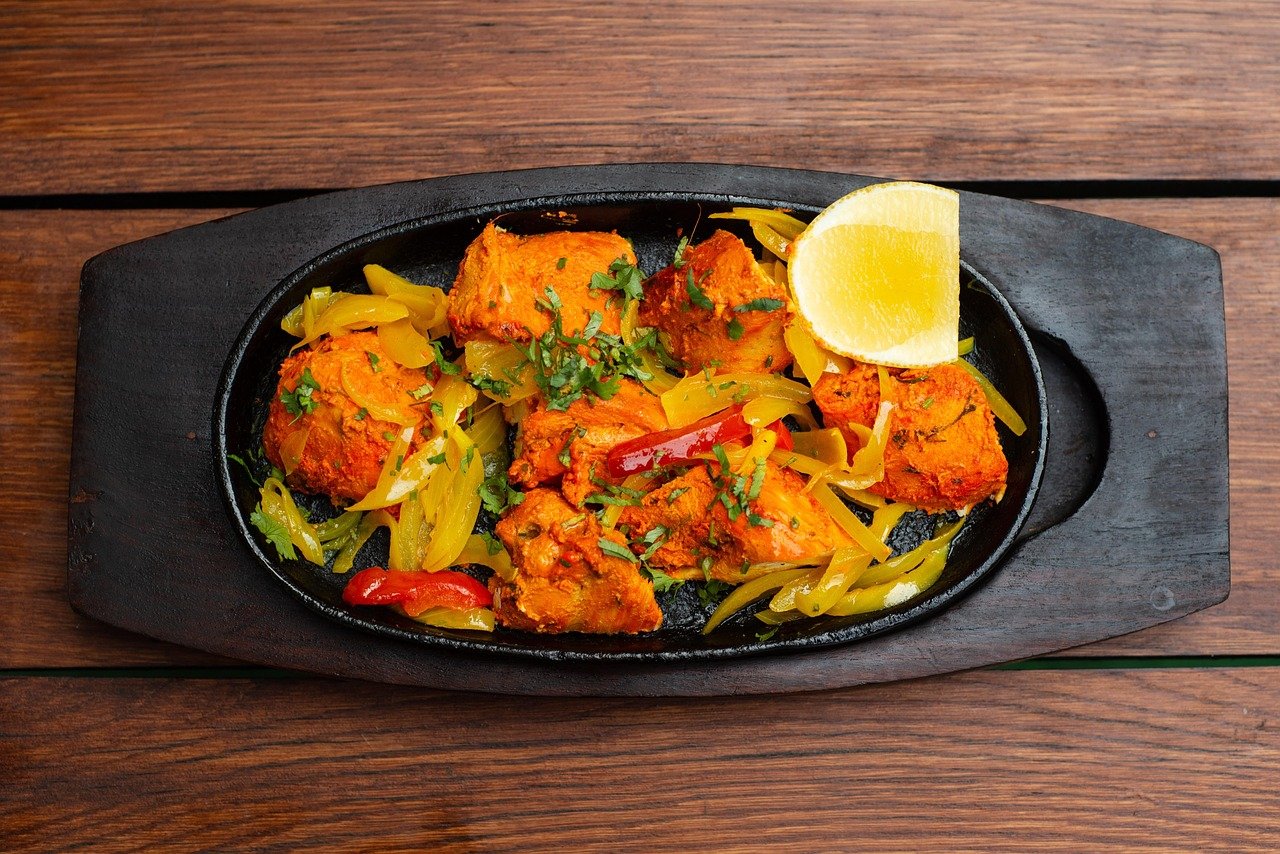 Chicken Tikka at Tandoori Trails Victoria BC - tandoor-marinated chicken on cast iron